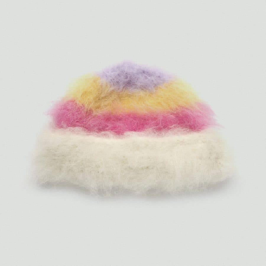 A fluffy striped Wielonki beanie in pink, yellow and lilac